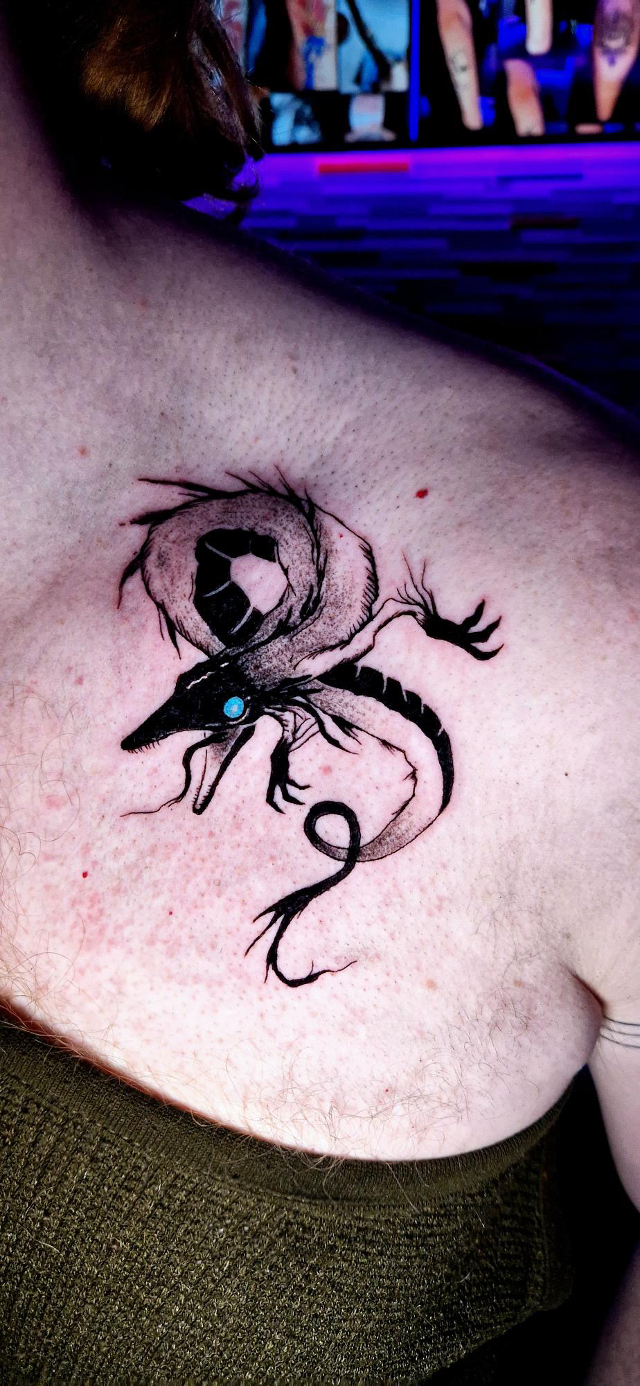 Black work style dragon tattoo