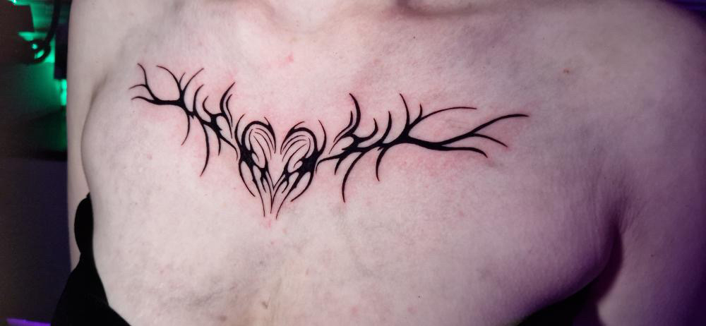 Upper ladies chest tattoo