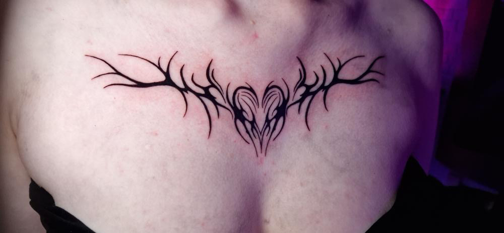 Upper ladies chest tattoo
